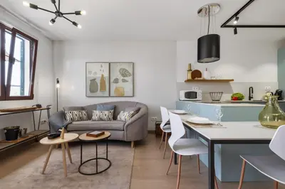 a living room with a couch and a table at Casa das Rosas - By Wehost in Santa Cruz