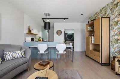 a living room with a couch and a table at Casa das Rosas - By Wehost in Santa Cruz