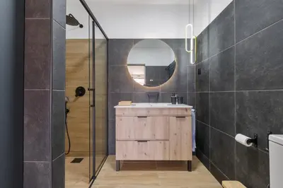 a bathroom with a sink and a mirror at Casa das Rosas - By Wehost in Santa Cruz