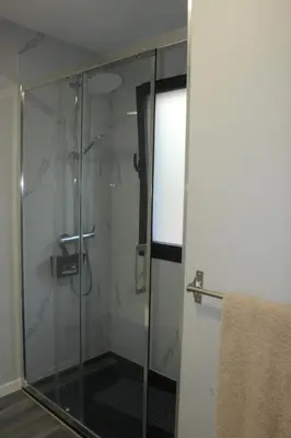 a shower with a glass door in a bathroom at Nature Apartment 2 with Pool in Arco da Calheta
