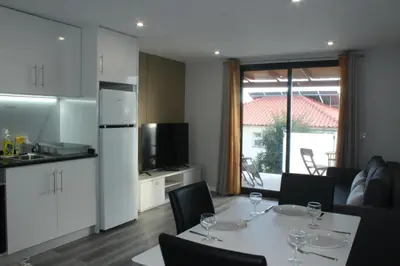 a kitchen and dining room with a table and chairs at Nature Apartment 2 with Pool in Arco da Calheta