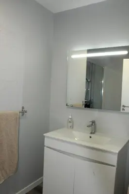 a white bathroom with a sink and a mirror at Nature Apartment 2 with Pool in Arco da Calheta