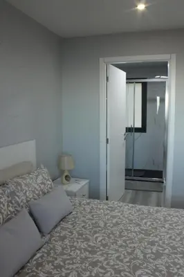 a bedroom with a bed and a sliding glass door at Nature Apartment 1 with Pool in Arco da Calheta
