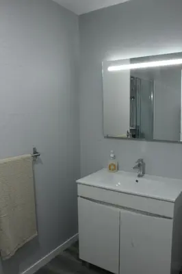 a white bathroom with a sink and a mirror at Nature Apartment 1 with Pool in Arco da Calheta