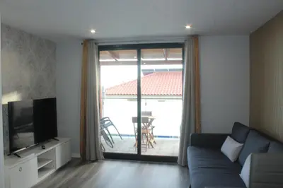 a living room with a couch and a sliding glass door at Nature Apartment 1 with Pool in Arco da Calheta