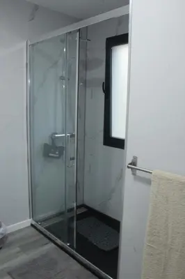 a shower with a glass door in a bathroom at Nature Apartment 1 with Pool in Arco da Calheta