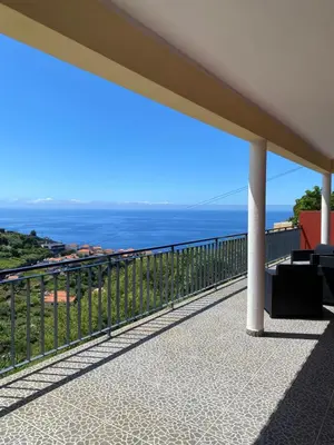 a balcony with a view of the ocean at Rocha House in Calheta