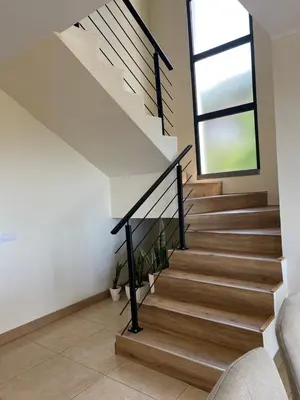 a staircase in a house with a window at Rocha House in Calheta