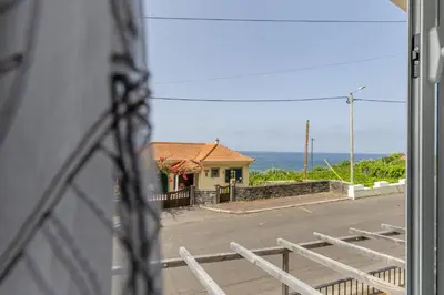 a view of a house from a window at Coastal São Vicente Mountain & Sea View Hideaway with Free Parking in São Vicente