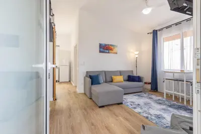 a living room with a couch and a table at Coastal São Vicente Mountain & Sea View Hideaway with Free Parking in São Vicente