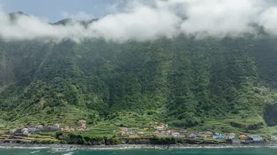 a village on a hill in the middle of the ocean at Coastal São Vicente Mountain & Sea View Hideaway with Free Parking in São Vicente