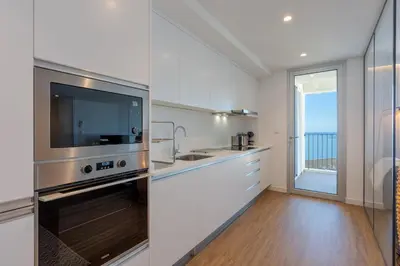 a bedroom with a bed with two towels on it at Atlantic Nest Apartment by Holiday Rental Madeira in Câmara de Lobos