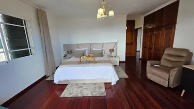 a kitchen with white cabinets and a table with chairs at Santa Maria Villa in Funchal
