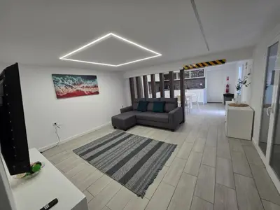 a living room with a couch and a table at Villa Rodrigues 3 by Rentallido in Campanário