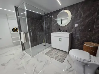 a bathroom with a shower and a toilet and a sink at Villa Rodrigues 3 by Rentallido in Campanário