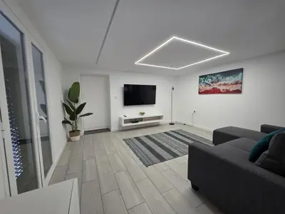 a living room with a couch and a flat screen tv at Villa Rodrigues 3 by Rentallido in Campanário
