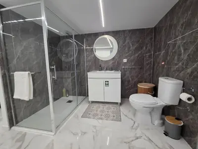 a bathroom with a shower and a toilet and a sink at Villa Rodrigues 3 by Rentallido in Campanário
