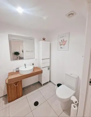 a white bathroom with a sink and a toilet at Garajau Residence Sea View by Rentallido in Caniço