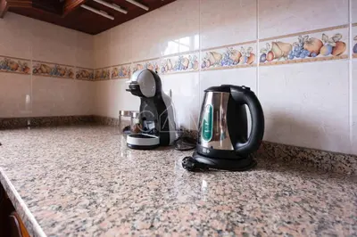 a hair dryer sitting on a counter in a kitchen at Recanto do Estreito by GALMI in Estreito da Calheta