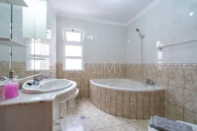 a bathroom with a bath tub and a sink at Recanto do Estreito by GALMI in Estreito da Calheta