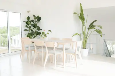 a white dining room with a white table and chairs at Algarve Windmill, Villa and Pool 2000m to the Beach in Figueira