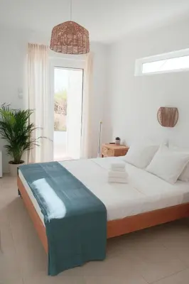 a white bedroom with a large bed with a window at Algarve Windmill, Villa and Pool 2000m to the Beach in Figueira