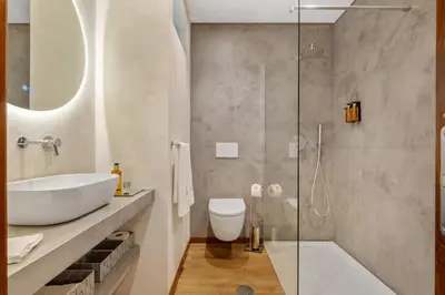 a bathroom with a sink and a toilet and a shower at Marrom Mystique in Canhas
