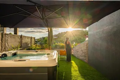a woman standing in front of a jacuzzi tub at Marrom Mystique in Canhas