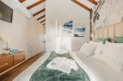 a bedroom with a bed with towels on it at Marrom Mystique in Canhas
