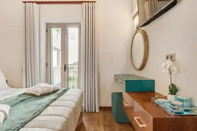 a bedroom with a bed and a dresser and a mirror at Marrom Mystique in Canhas