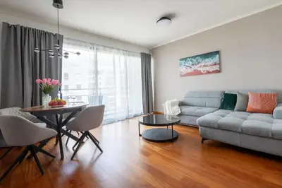 a living room with a couch and a table at Sky View - Spacious Stay with Pool & Gym in Funchal