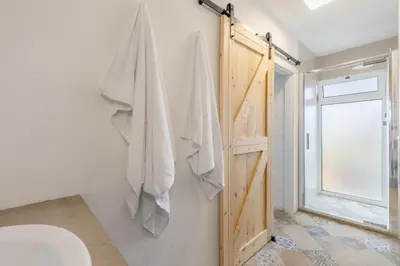 a bathroom with a toilet and a window at Scenic Home with Panoramic Sea & Mountain Views in São Vicente in São Vicente
