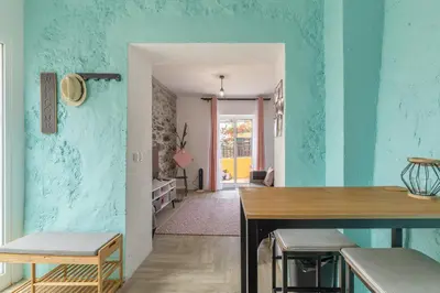 a room with blue walls and a table and chairs at Scenic Home with Panoramic Sea & Mountain Views in São Vicente in São Vicente