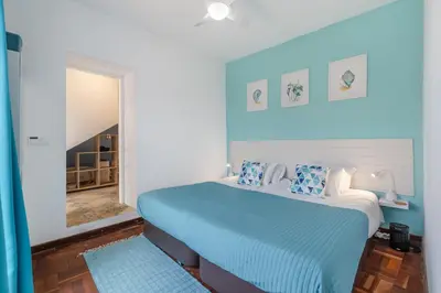 a bedroom with a bed and a mirror at Scenic Home with Panoramic Sea & Mountain Views in São Vicente in São Vicente