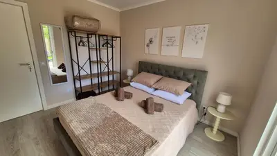 a bedroom with a blue bed and a chair at Chalé da Serra in Santo da Serra