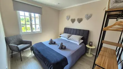 a bedroom with a bed with towels on it at Chalé da Serra in Santo da Serra
