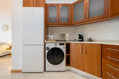 a kitchen with a washing machine in a kitchen at Porto de Abrigo in Burgau