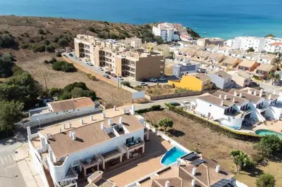 an aerial view of a resort with the ocean at Porto de Abrigo in Burgau