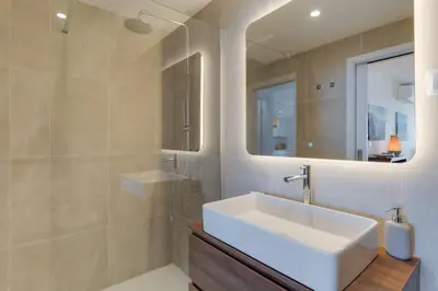 a bedroom with a bed with two towels on it at Pearl Retreat by Holiday Rental Madeira in Câmara de Lobos