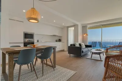 a balcony with a view of the ocean at Pearl Retreat by Holiday Rental Madeira in Câmara de Lobos