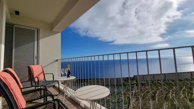 a living room with chairs and a table at Pearl Retreat by Holiday Rental Madeira in Câmara de Lobos