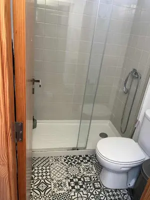 a bathroom with a shower and a toilet in it at Casa Herbarium in Prazeres