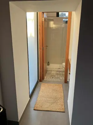 a bathroom with a walk in shower and a glass door at Casa Herbarium in Prazeres