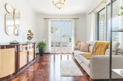 a living room with a couch and a table at Casa do Pico by Atlantic Holiday in Câmara de Lobos