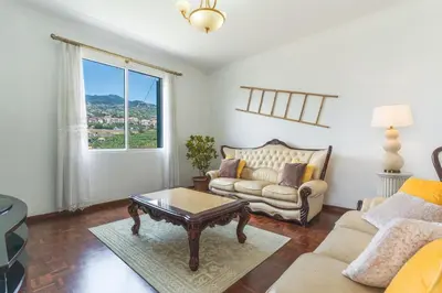 a living room with a couch and a coffee table at Casa do Pico by Atlantic Holiday in Câmara de Lobos