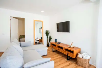 a living room with a couch and a table at Joana's House in Camacha