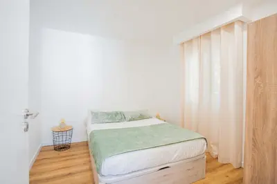 a small bedroom with a bed and a window at Joana's House in Camacha