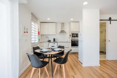 a kitchen and dining room with a table and chairs at Joana's House in Camacha