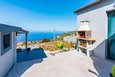 a view of a house with an outdoor oven at Casa D'Avó Bela in Arco da Calheta
