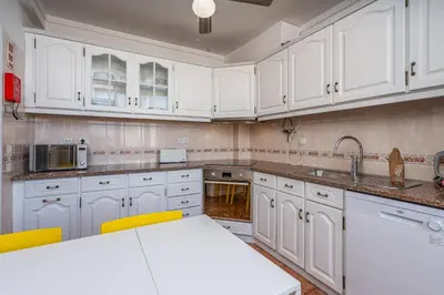 a kitchen with white cabinets and a white counter top at Lovely beach apartment, sea views, rooftop terrace #1974 in Budens